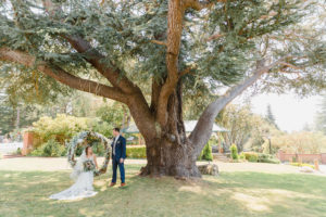 a bride sitting in a floral swing at lairmont manor