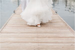 a woman walking on a boardwalk in her wedding dress at her wedding at the skansonia in seattle
