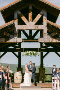 a couple standing at a wedding alter in Suncadia at Swiftwater Cellars