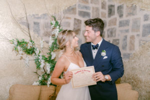 Couple celebrating marriage with certificate.