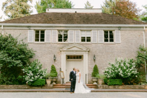 bride and groom standing in front of lakewold gardens wedding venue in seattle