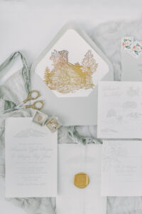 wedding flatlay in a blue and grey hue with a pop of gold