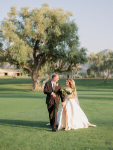 a father giving his daughter away at her palm springs wedding on a golf course