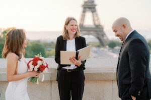 a sunrise paris elopement with an officiant laughing at the groom