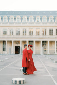 a bride and groom in red outfits symbolizing their asian culture at the palais royal in paris for their wedding photos
