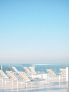 white pool chairs santorini at a resort for a honeymoon