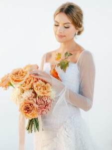 a bride holding her bridal bouquet at her santorini elopement