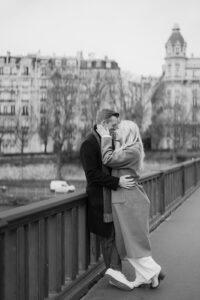 a couple embraced on a bridge in paris france for their engagement photos