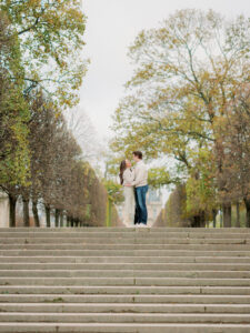 a man and woman at the top of some stairs at jardin du luxemberg in paris