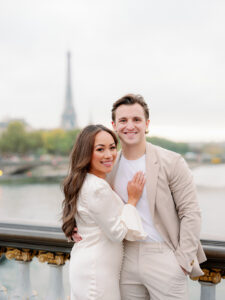 a mand and woman nicely dressed on the pont alexandre bridgefor their paris engagement shoot in front of the eiffel tower