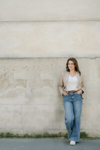 a woman standing against a wall in paris france
