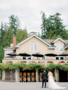 a bride and groom walking in front of chateau lill in woodinville washington