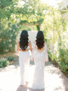 macarthur place wedding with two women wearing white wedding dresses walking away from the camera