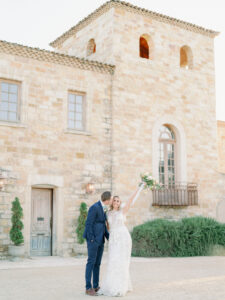 bride and groom standing in front of sunstone winery in california for their winery wedding