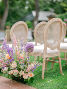 elegant wooden wedding chairs and flowers set up for the aisle at a wedding at the lairmont manor