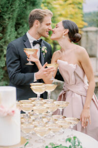 a couple kissing with champagne in their hands at villa cetinale in tuscany