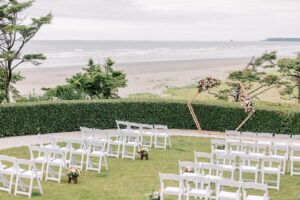 a wedding ceremony setup overlooking the beach for this waterfront wedding venues in washington state