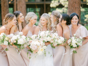 bride and bridesmaids looking at one another and laughing