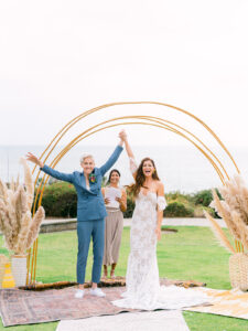 two brides in california celebrate at their wedding ceremony overlooking the ocean