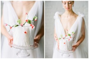 a bride holding a wedding cake in a white brick studio in tacoma washington