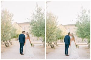 a bride and groom holding hands and walking away from the camera in a row of trees at sunstone winery