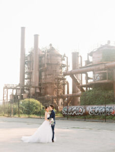 a bride and groom kissing at gasworks park in seattle for their wedding photos