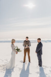 a bride and groom in the snow on a glacier for their elopement in iceland