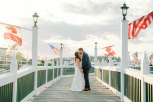a bride and groom kissing on a pier at their wedding at roche harbor resort