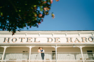 a couple kissing on the balcony of Hotel De Haro at their micro wedding at Roche Harbor Resort