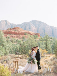 two brides at an alter in sedona for their sunrise elopement