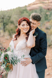 two brides laughing and smiling while looking at each other at their sedona elopement