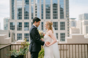 a bride and groom facing each other at their downtown seattle wedding venue