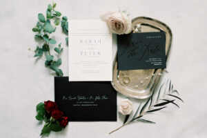 a wedding flatlay with black, white and red accents
