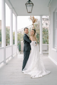 a bride and groom on a porch at their gadsden house elopement