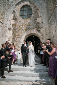 a bride and groom exiting the church after their wedding in champagne france