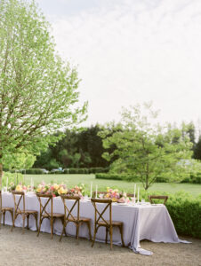 a wedding reception table with wooden chairs at a small wedding 