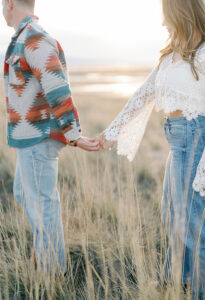 a couple holding hands at their saltair engagement session