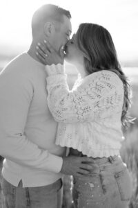 black and white photo of a man and woman kissing at their saltair engagement session