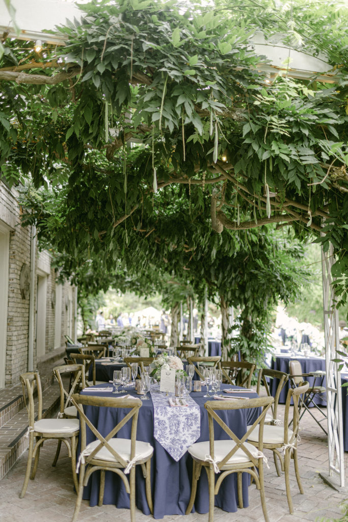 outdoor wedding reception with natural greenery covering