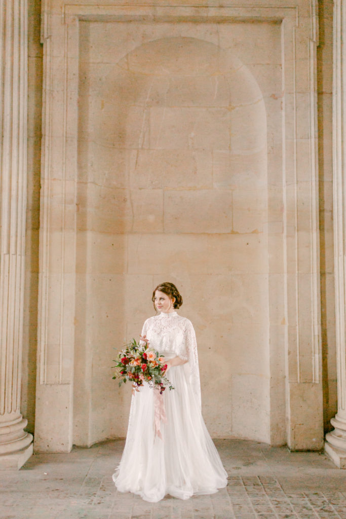 bride in paris holding her bouquet and looking off into the distance