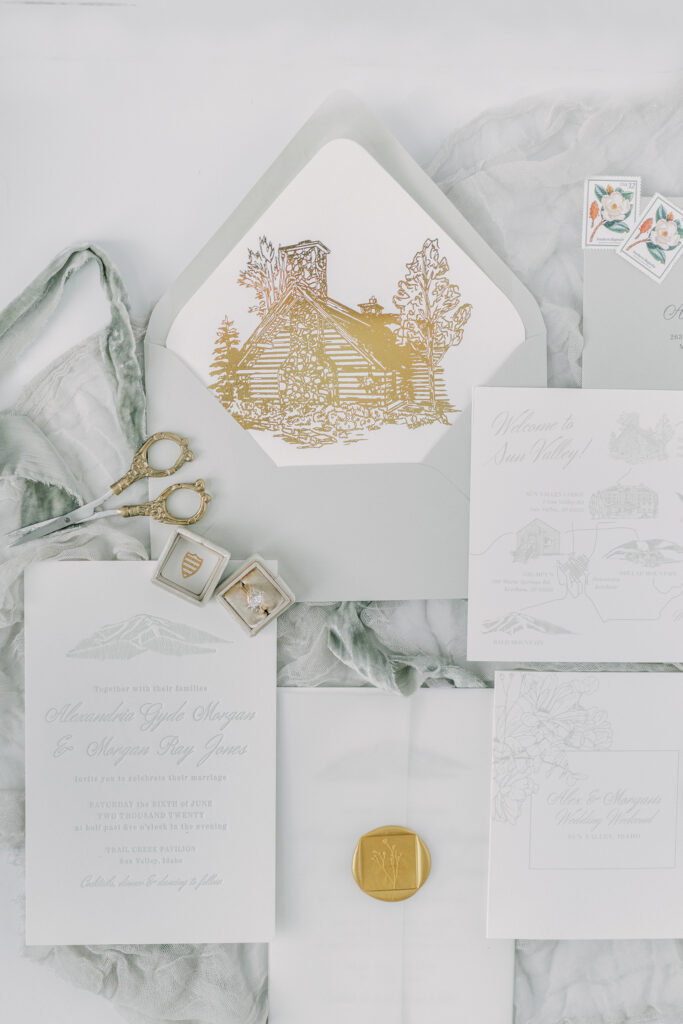 wedding flatlay in a blue and grey hue with a pop of gold