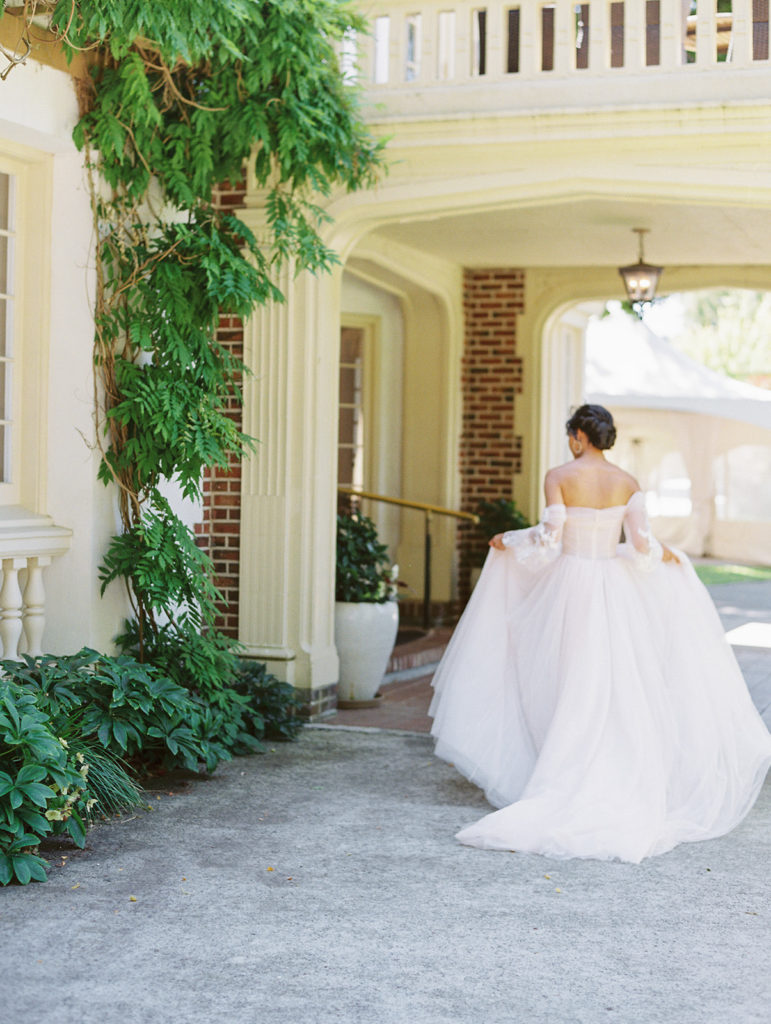 bride walking away from camera in a pink wedding dress