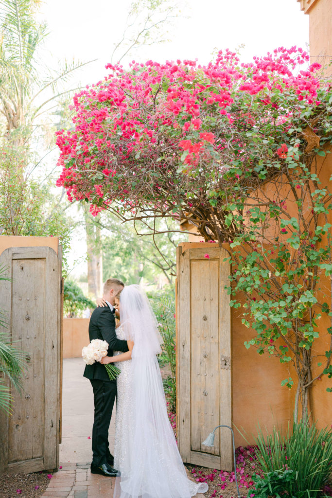 bride and groom in doorway hugging and embracing at the royal palms resort