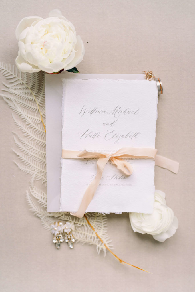 wedding invitation detail with ribbon and florals