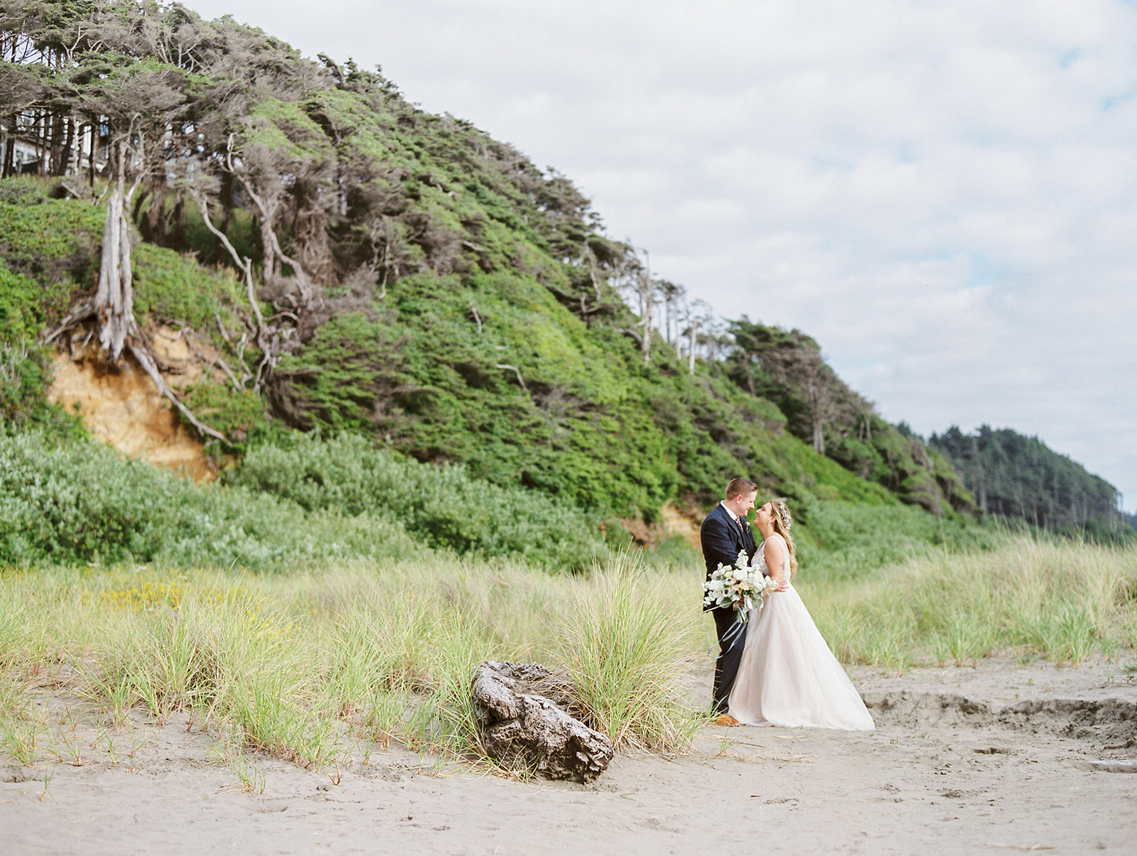 a bride and groom on a beach at seabrook for their wedding