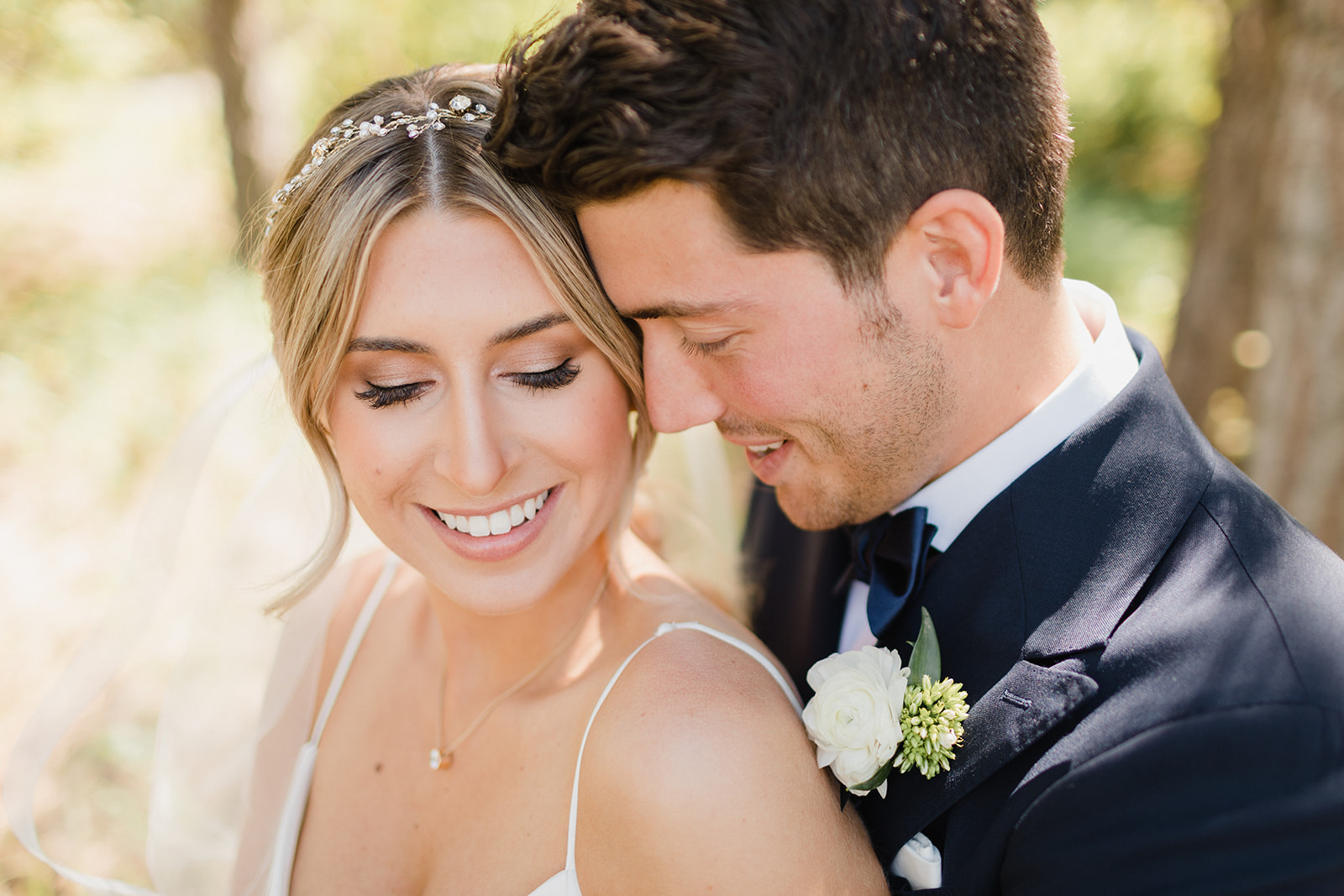 a close up of a bride and groom with their foreheads together and looking down at their swiftwater cellars wedding