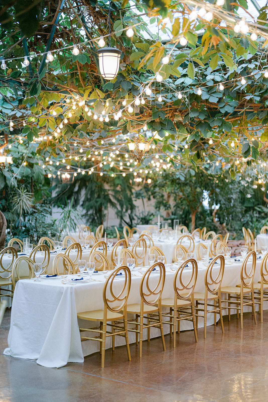 a utah wedding venue with gold chairs and twinkling lights that look like you are inside a garden