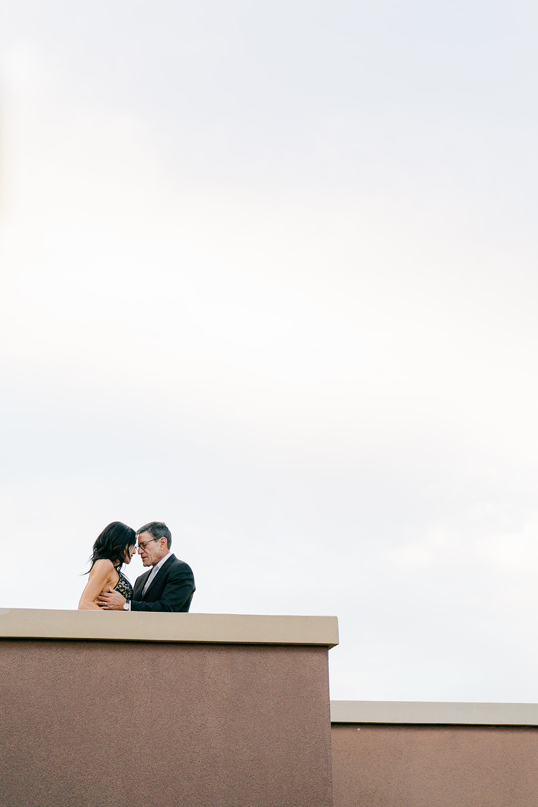 a bride and groom on a ledge at their ballroom wedding in scottsdale
