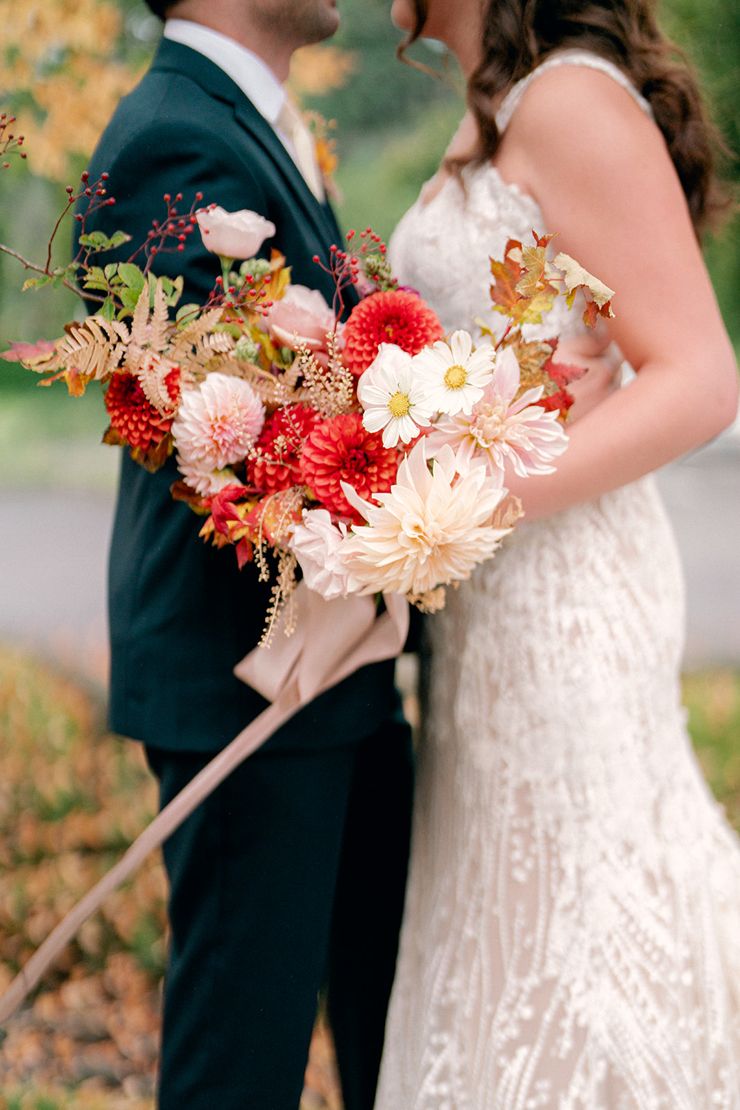 a bride and groom kissing while the bride is holding a colorful bouquet at their woodinville winery wedding at columbia collective