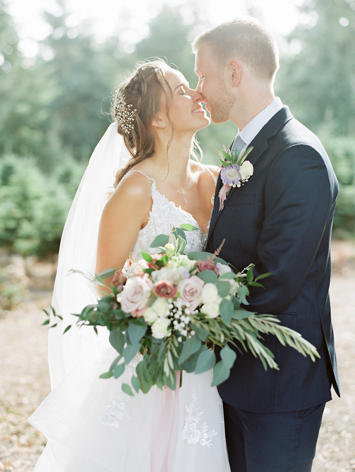 a bride and groom about to kiss at their wedding at trinity tree farm wedding venue